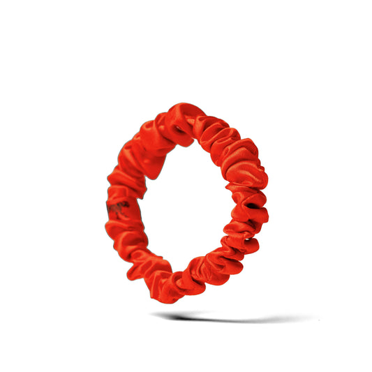 Organic silk small scrunchie in tomato red by LINA LENNOX, soft and stylish hair accessory on a white background.