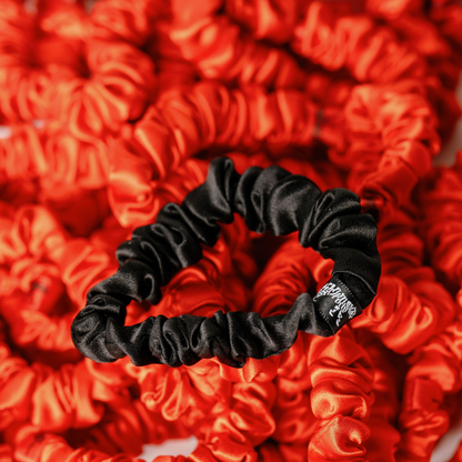Organic silk small scrunchie in tomato red by LINA LENNOX, featuring a soft, smooth texture and elastic hair accessory.