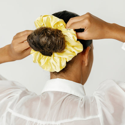 Organic silk oversized scrunchie in sunshine yellow by LINA LENNOX, shown in close-up with soft fabric texture.