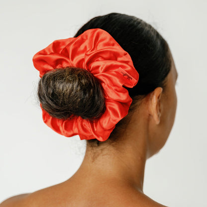 Organic silk oversized scrunchie by LINA LENNOX in vibrant tomato red, soft and luxurious for gentle hair styling.
