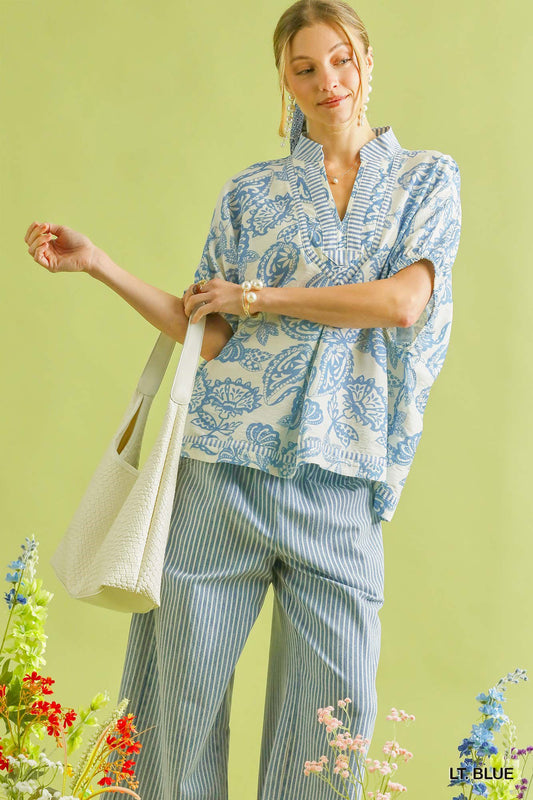 Light blue Umgee botanical print mixed trim tunic top with relaxed fit and stylish design, perfect for casual wear.