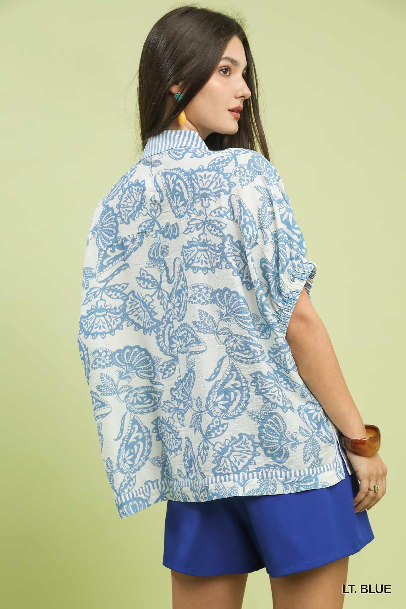 Light blue Umgee botanical print mixed trim tunic top with relaxed fit and stylish design, perfect for casual wear.
