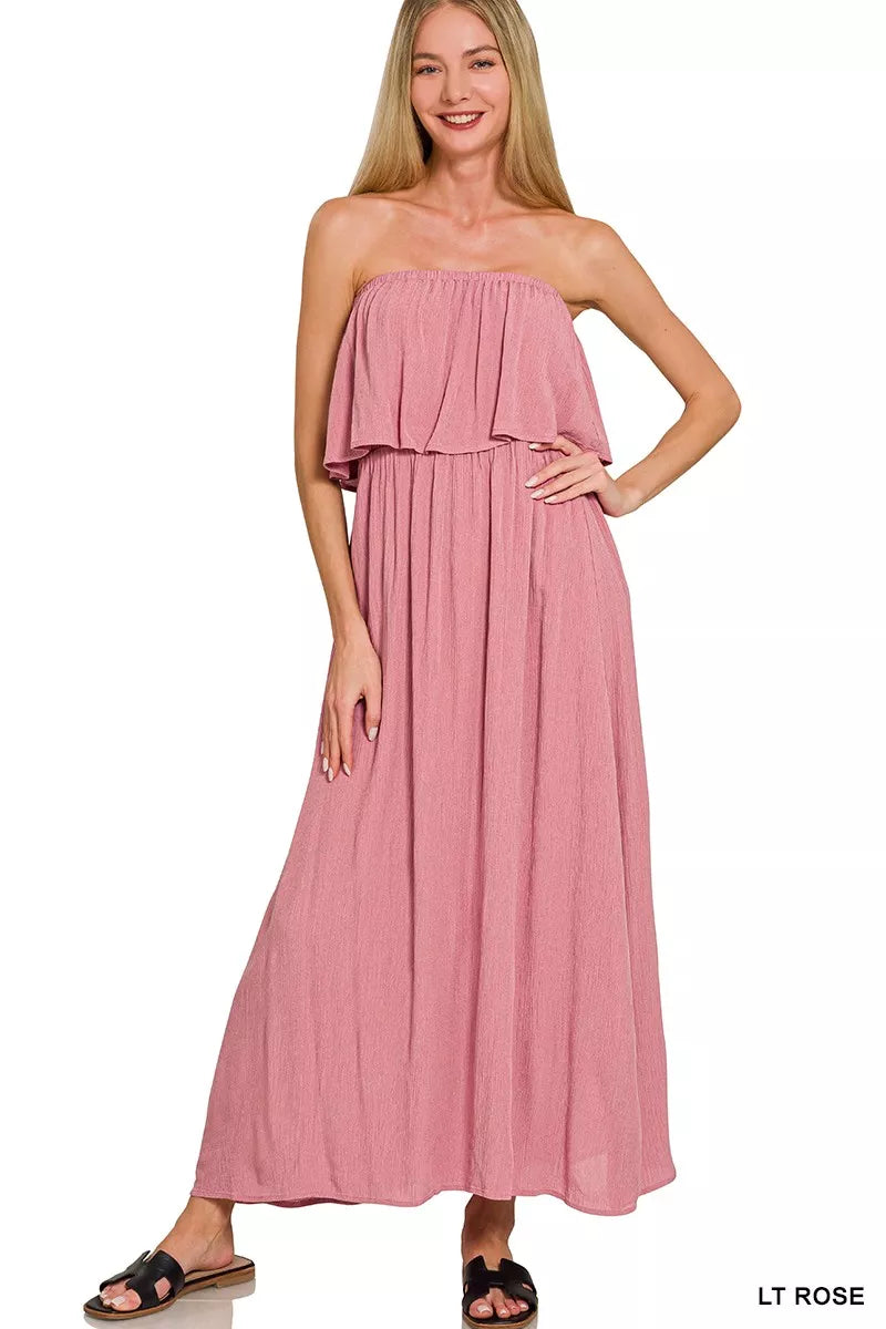 Light pink Zenana woven crinkle strapless maxi dress from Trendsi, featuring a flowing silhouette and elegant design.