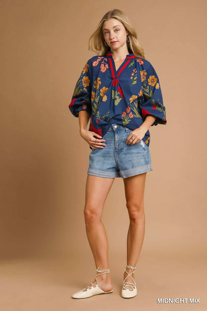 Umgee floral print flounce sleeve blouse with midnight mix colors, showcasing its stylish design and lightweight fabric.