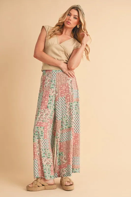 Mint pink Aemi+Co printed wide-leg pants with a relaxed fit and floral pattern, perfect for casual or stylish outfits.