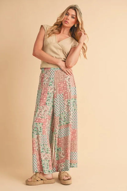 Mint pink Aemi+Co printed wide-leg pants with a relaxed fit and floral pattern, perfect for casual or stylish outfits.