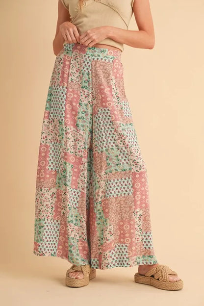 Mint pink Aemi+Co printed wide leg pants by Trendsi, showcasing their flowy fabric and stylish wide-leg design.