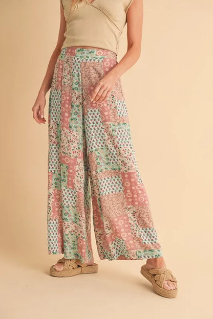 Mint pink Aemi+Co printed wide-leg pants with a relaxed fit, displayed on a hanger. Perfect for casual and stylish looks.