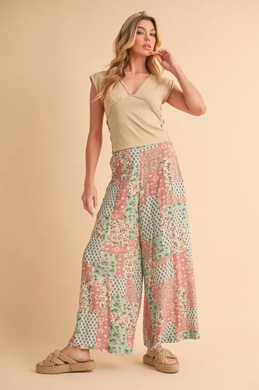 Mint pink Aemi+Co printed wide-leg pants with a relaxed fit and bold pattern, perfect for casual and stylish looks.
