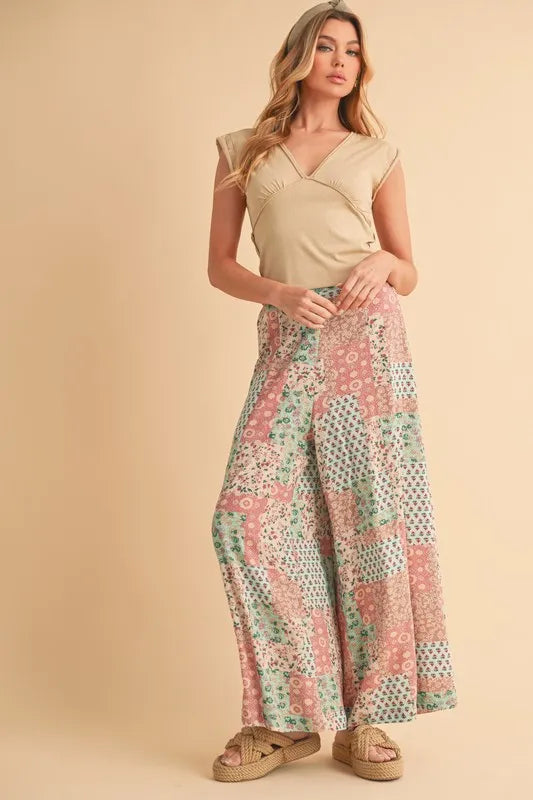 Mint pink Aemi+Co printed wide-leg pants by Trendsi, showcasing a flowy, comfortable design with a stylish floral pattern.