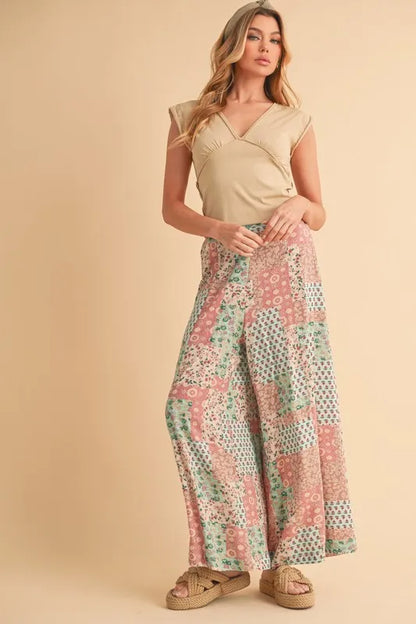 Mint pink Aemi+Co printed wide-leg pants by Trendsi, showcasing a flowy, comfortable design with a stylish floral pattern.