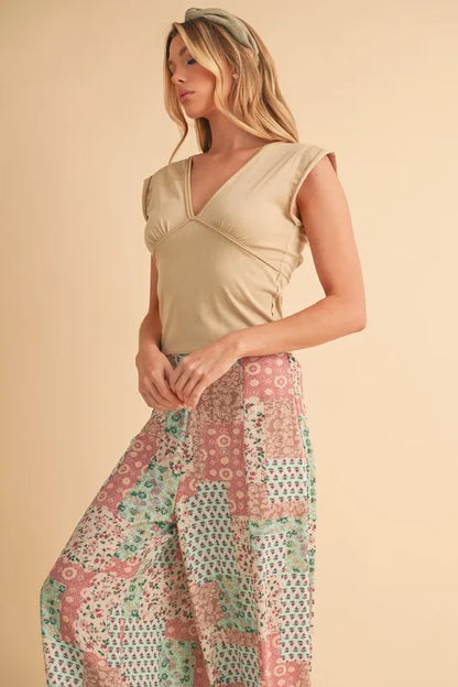 Mint pink Aemi+Co printed wide-leg pants by Trendsi, featuring a relaxed fit and stylish floral pattern.