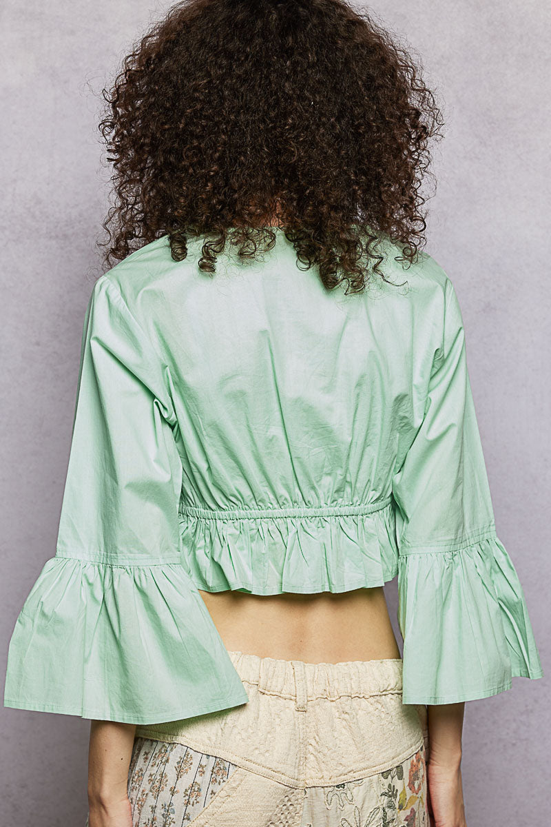 Mint POL floral embroidered cropped blouse by Trendsi, showing intricate embroidery and lightweight fabric details.