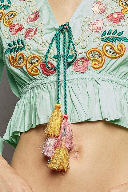 Mint POL floral embroidered cropped blouse from Trendsi, featuring intricate embroidery and a stylish, summery design.