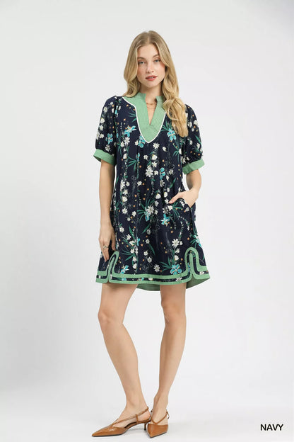 Navy Umgee floral puff sleeve dress with contrast trim, featuring a feminine silhouette and lightweight fabric.