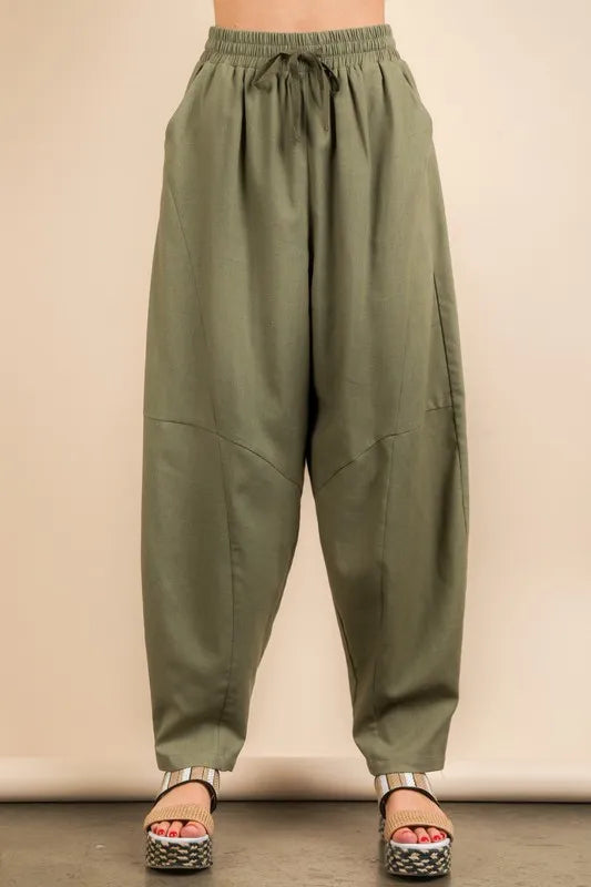 Olive green Very J Solid Barrel Comfy Woven Pants by Trendsi, showing relaxed fit and elastic waistband on model.