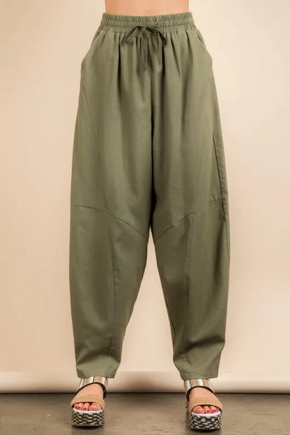 Olive green Very J Solid Barrel Comfy Woven Pants by Trendsi, showing relaxed fit and elastic waistband on model.