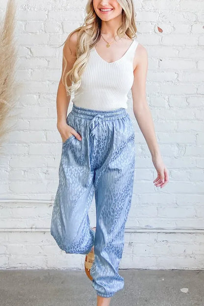 Pale blue satin leopard print joggers from And The Why by Trendsi, featuring a relaxed fit and stylish animal pattern.