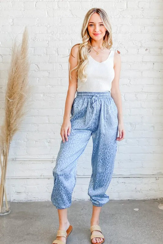 Pale blue satin leopard print joggers from And The Why by Trendsi, featuring a relaxed fit and stylish animal pattern.