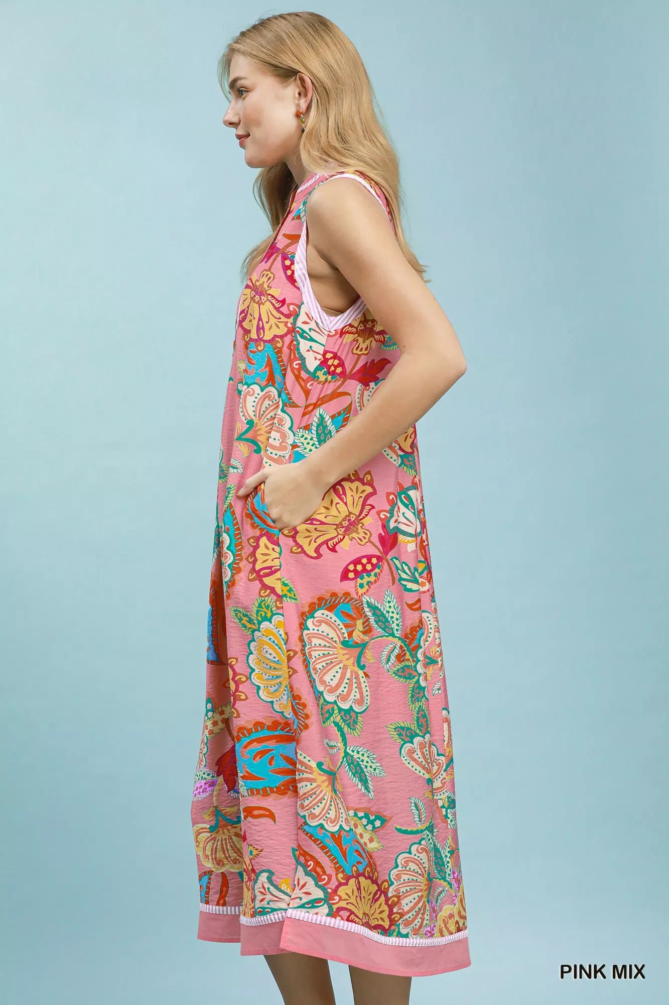 Pink mixed paisley floral sleeveless midi dress by Umgee, showcasing a flowy, bohemian style with a fitted waist and vibrant pattern.