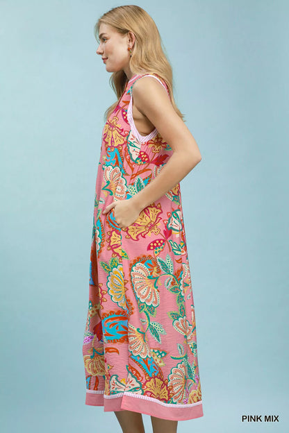Pink mixed paisley floral sleeveless midi dress by Umgee, showcasing a flowy, bohemian style with a fitted waist and vibrant pattern.