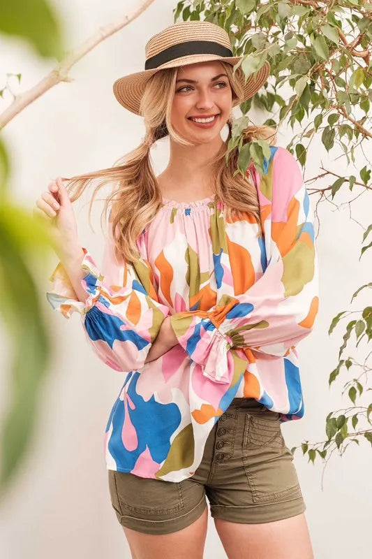 Pink off-the-shoulder long sleeve top with lime and chili abstract print by Trendsi. Stylish women's fashion top.