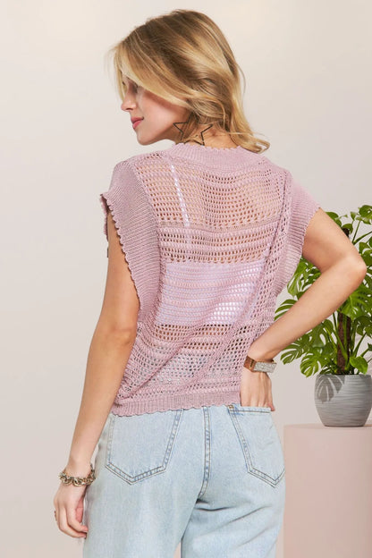Pink crochet top by Trendsi with drawstring details, featuring a fitted sleeveless design and intricate knit pattern.