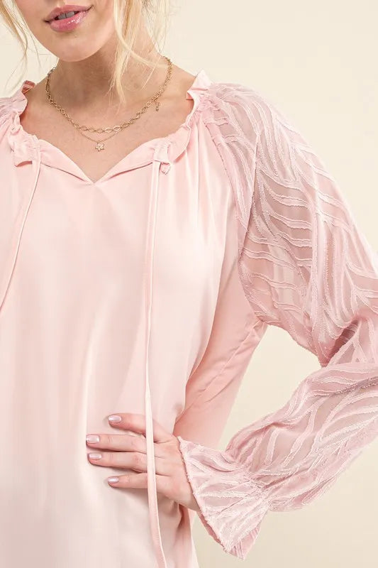 Pink blouse with textured leaf-shaped sleeves from Trendsi, stylish and lightweight for casual or dressy wear.