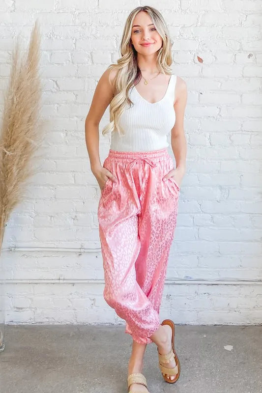 Pink satin leopard print joggers from And The Why by Trendsi, featuring a relaxed fit and stylish animal print pattern.