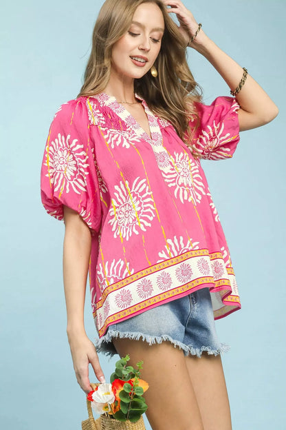Pink Umgee floral border smocked V-neck boho blouse with long sleeves and relaxed fit, stylish and feminine.