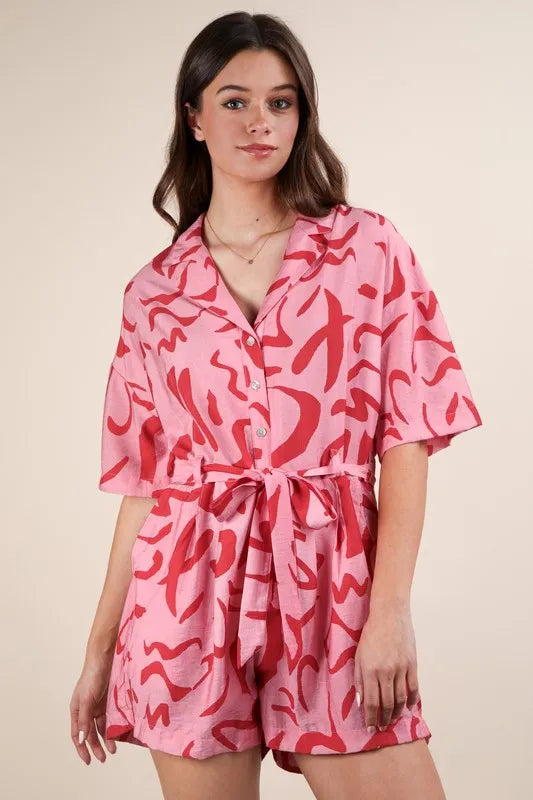 Pink Very J oversized printed button-down resort romper by Trendsi, featuring a relaxed fit and vibrant floral print.