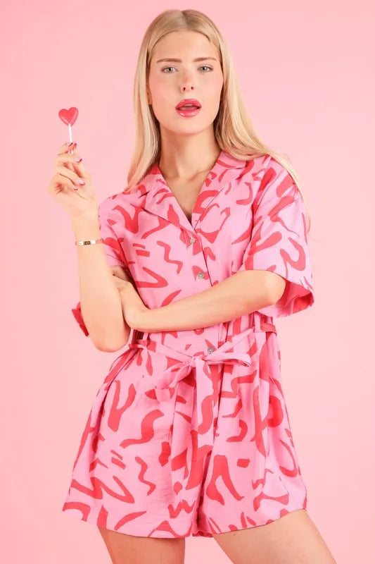 Pink oversized printed button-down resort romper from VERY J by Trendsi, featuring a relaxed fit and vibrant tropical print.
