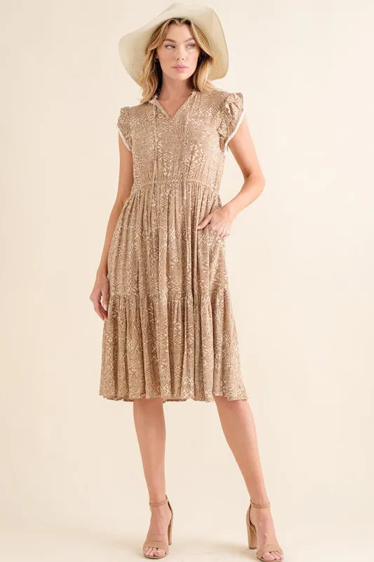 Taupe boho printed tiered maxi dress by Trendsi featuring a relaxed fit and flowing silhouette.