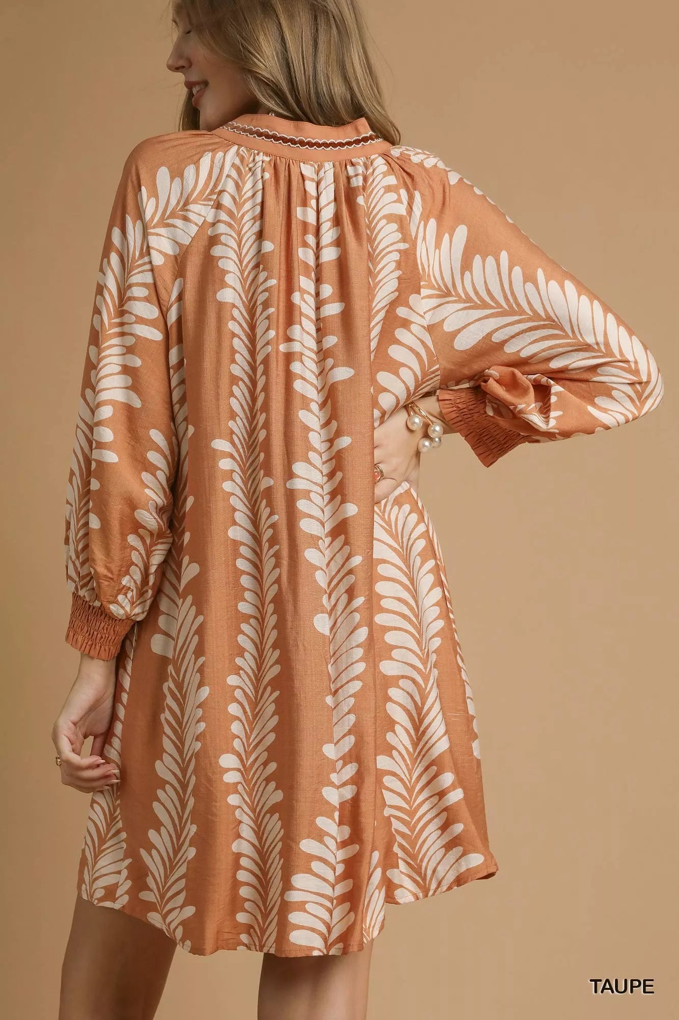 Taupe leaf print umgee mini babydoll dress with notched neckline, casual and chic, perfect for spring or summer wear.