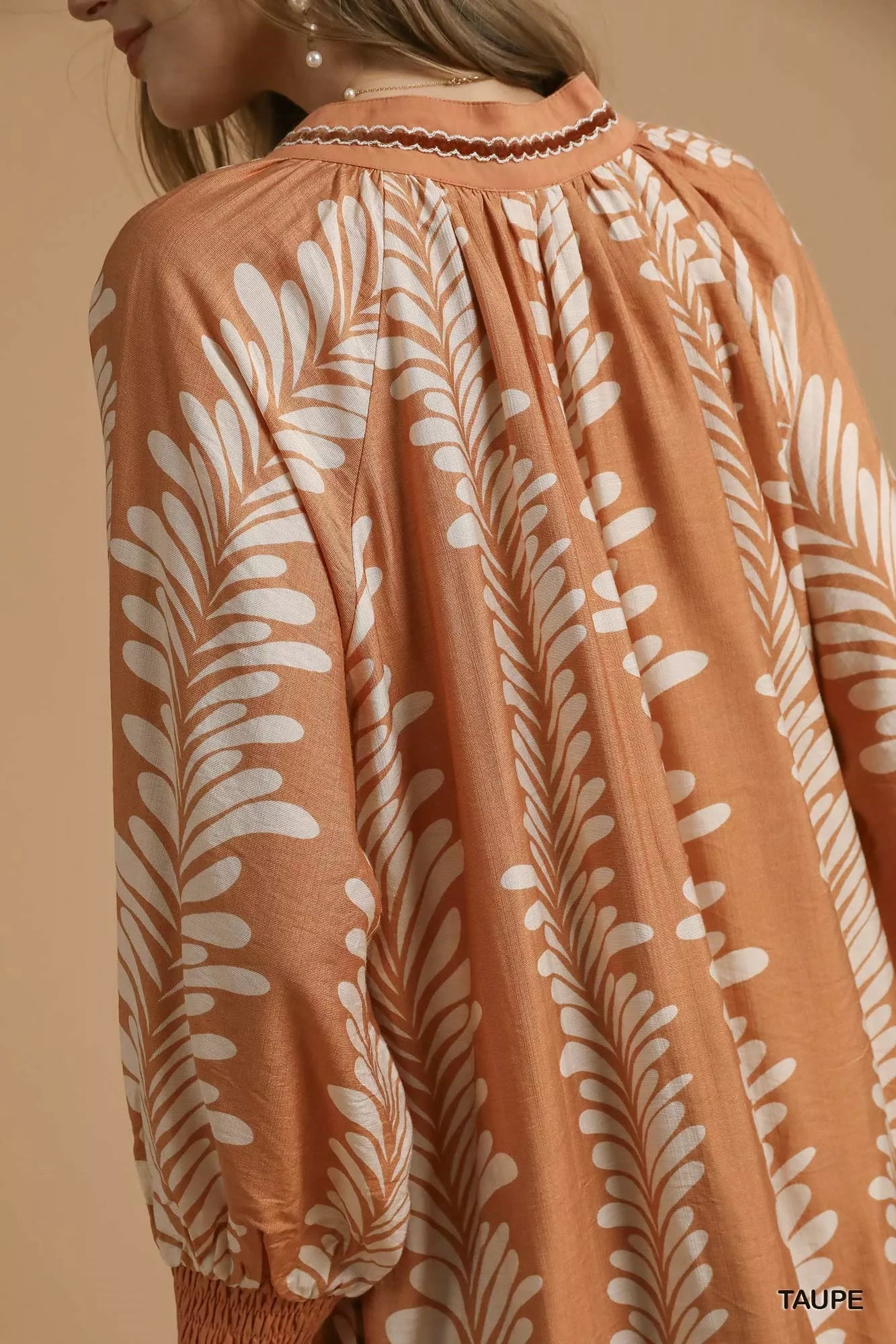 Taupe leaf print Umgee mini babydoll dress with notched neckline, featuring a flowy, relaxed fit and short sleeves.