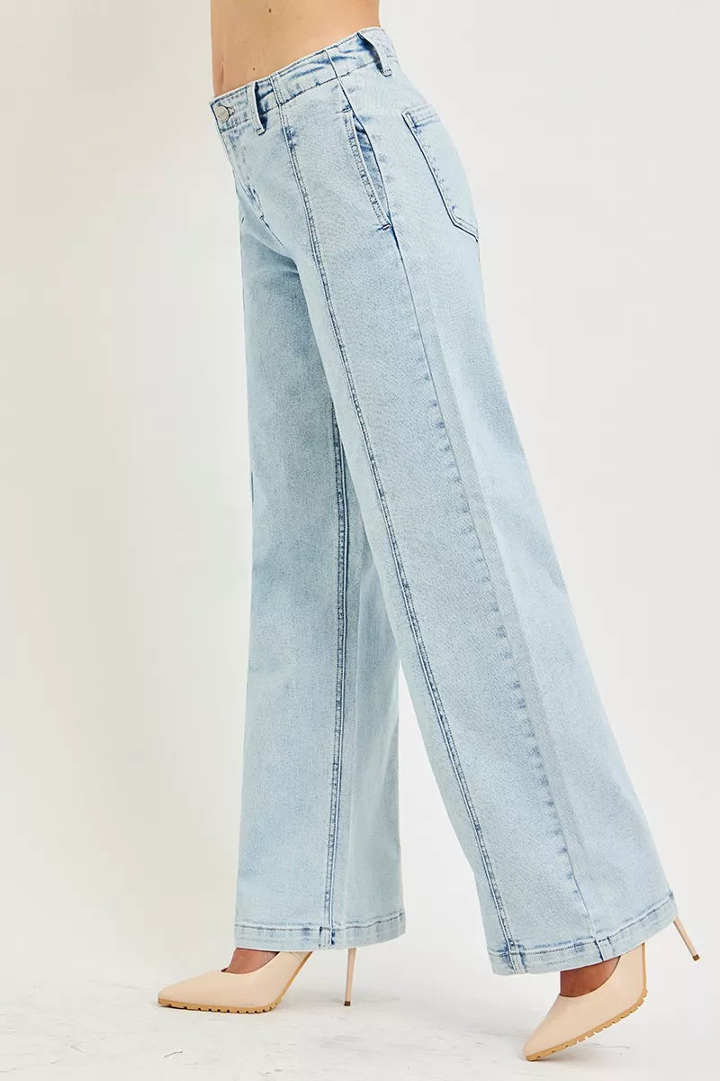 Light acid-wash RISEN slouchy wide-leg jeans from Trendsi, featuring relaxed fit and casual style with visible seams and distressed details.