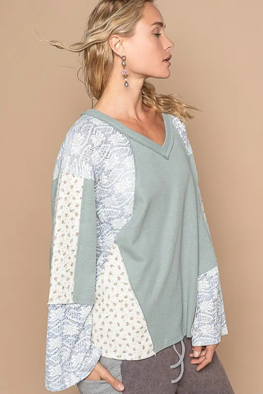 Air force blue POL Lace Floral Round Neck Knit Top by Trendsi, showcasing a close-up of the detailed lace floral pattern and round neckline.