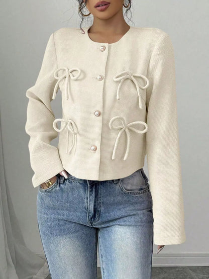 Apricot Bow Detail Cropped Outerwear by Trendsi, featuring a stylish cropped jacket with bow accents and textured fabric.