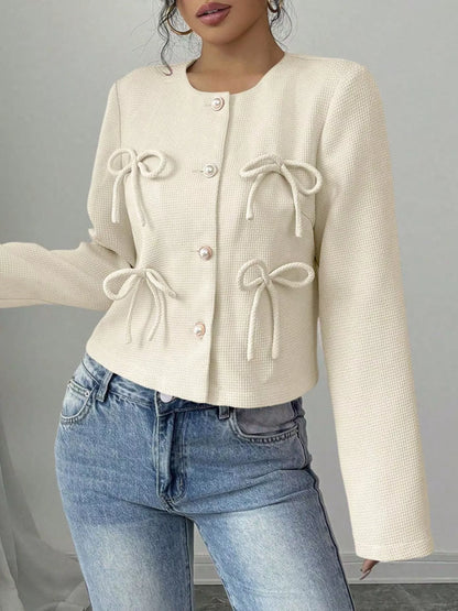 Apricot bow detail cropped outerwear by Trendsi, featuring a stylish design with a prominent bow accent and cropped fit.