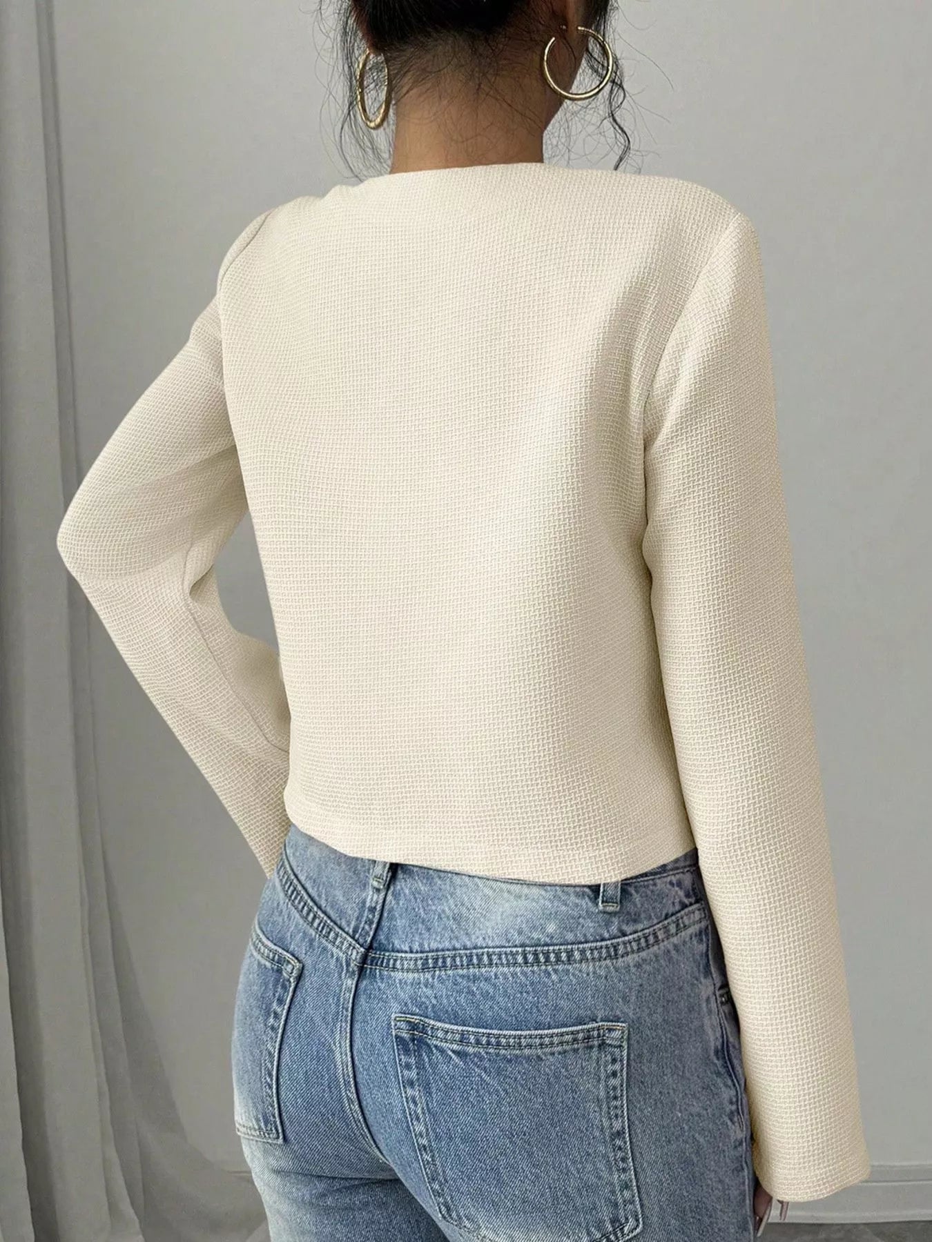 Apricot Bow Detail Cropped Outerwear by Trendsi featuring a stylish bow accent on a lightweight cropped jacket.