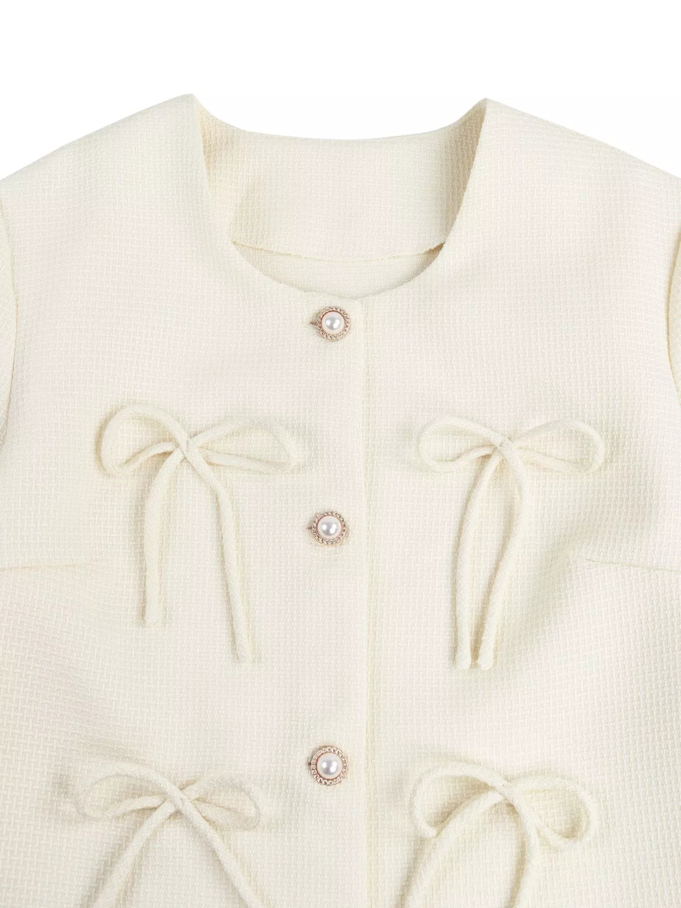 Apricot bow detail cropped outerwear by Trendsi, featuring a stylish bow accent and lightweight design for casual wear.