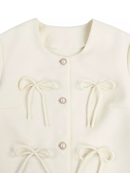 Apricot bow detail cropped outerwear by Trendsi, featuring a stylish bow accent and lightweight design for casual wear.
