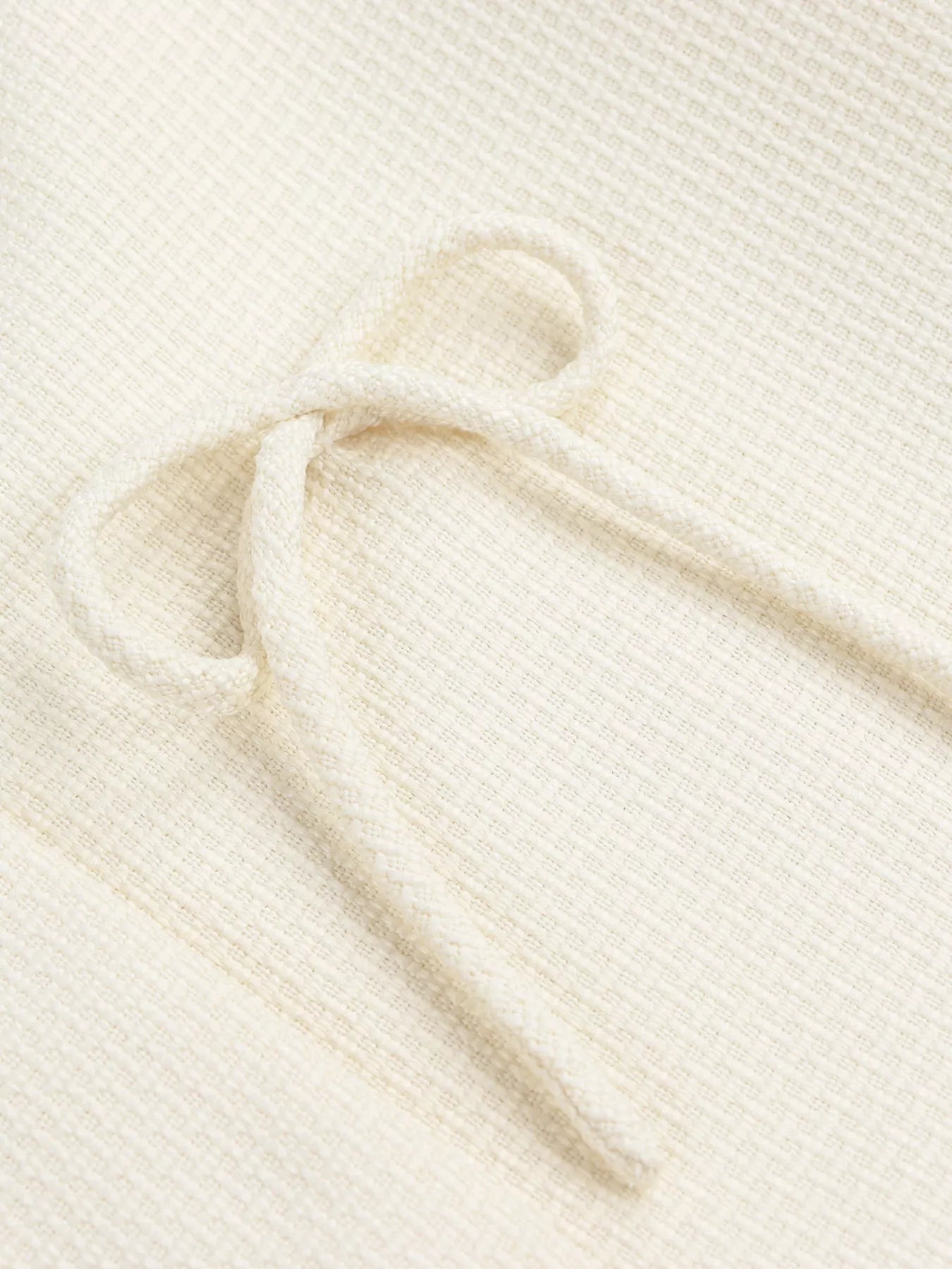 Apricot Bow Detail Cropped Outerwear by Trendsi, featuring a stylish bow accent and cropped fit in soft fabric.