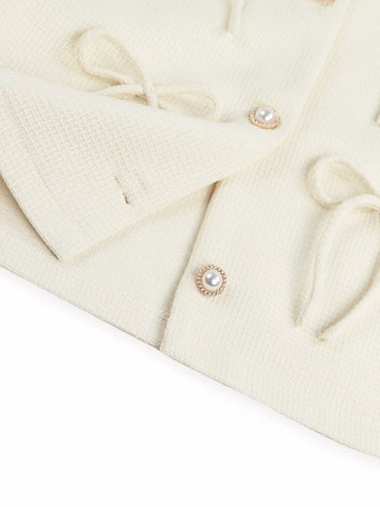 Apricot Bow Detail Cropped Outerwear by Trendsi featuring a stylish bow accent and cropped fit, perfect for layered fall outfits.