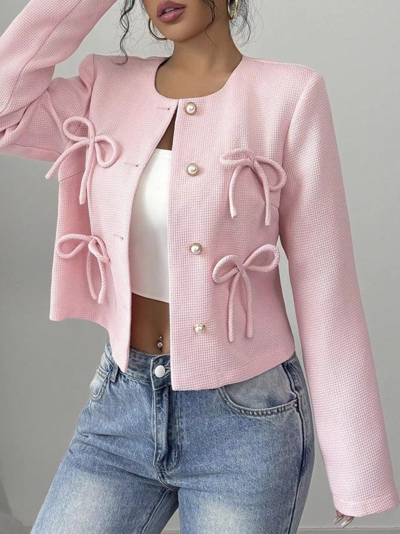 Apricot cropped outerwear with bow detail from Trendsi, featuring a stylish, fitted design perfect for casual or dressy wear.