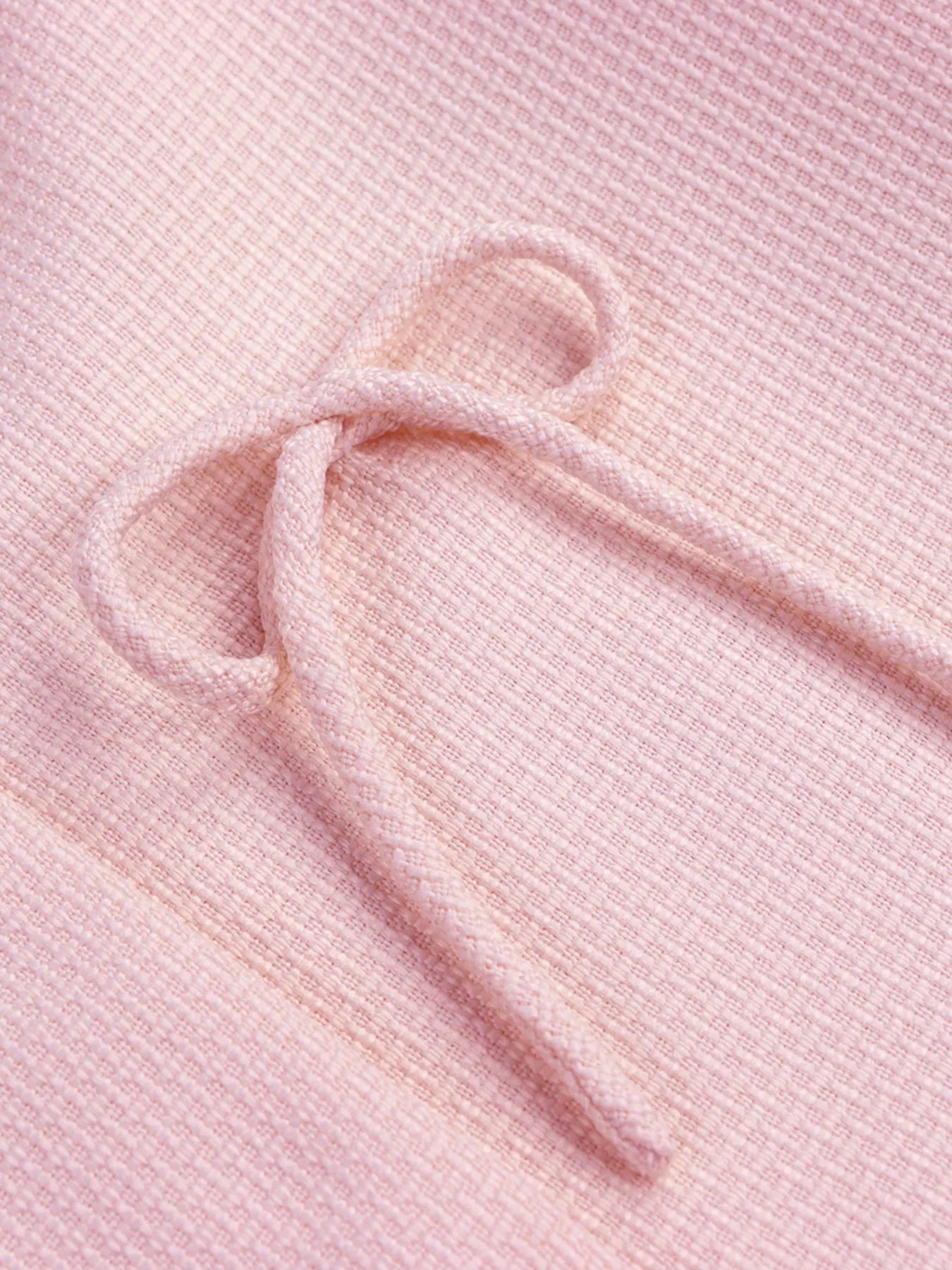 Apricot bow detail cropped outerwear by Trendsi, featuring a stylish bow accent on the front, perfect for layered winter outfits.