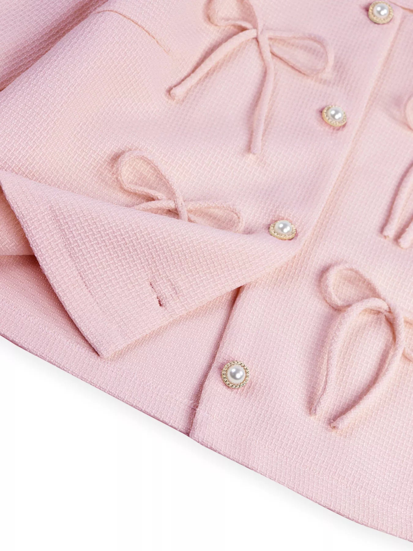 Apricot Bow Detail Cropped Outerwear by Trendsi, showcasing a stylish cropped jacket with bow accents and textured fabric.