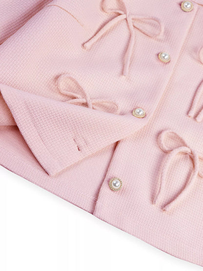 Apricot Bow Detail Cropped Outerwear by Trendsi, showcasing a stylish cropped jacket with bow accents and textured fabric.