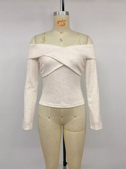 Apricot crisscross off-shoulder long sleeve top by Trendsi, featuring stylish design and fitted long sleeves.