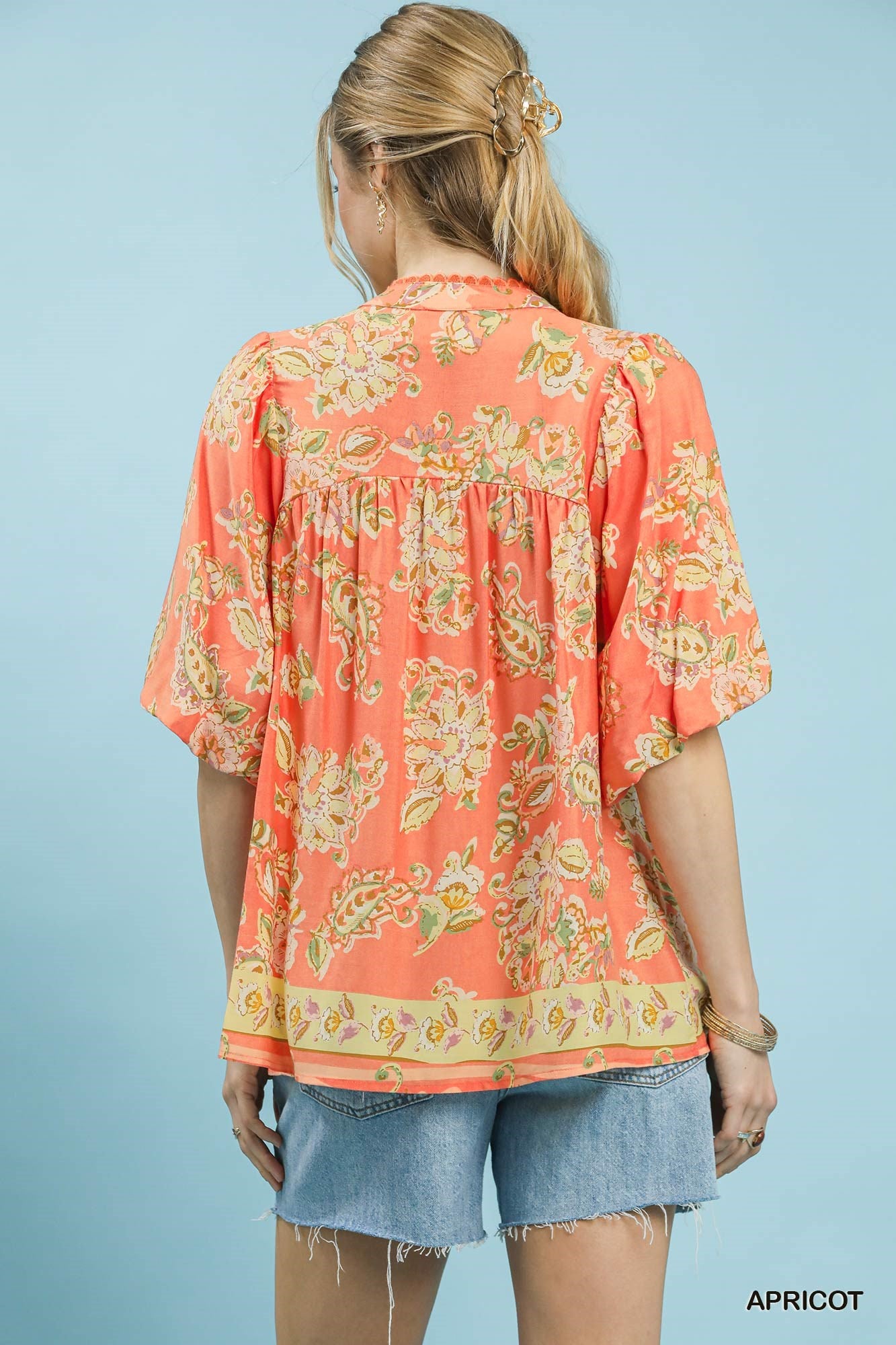 Umgee Apricot Floral Boho Blouse with long sleeves and ruffled details, featuring a vibrant apricot floral print.